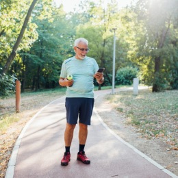 a man walking on a park trail