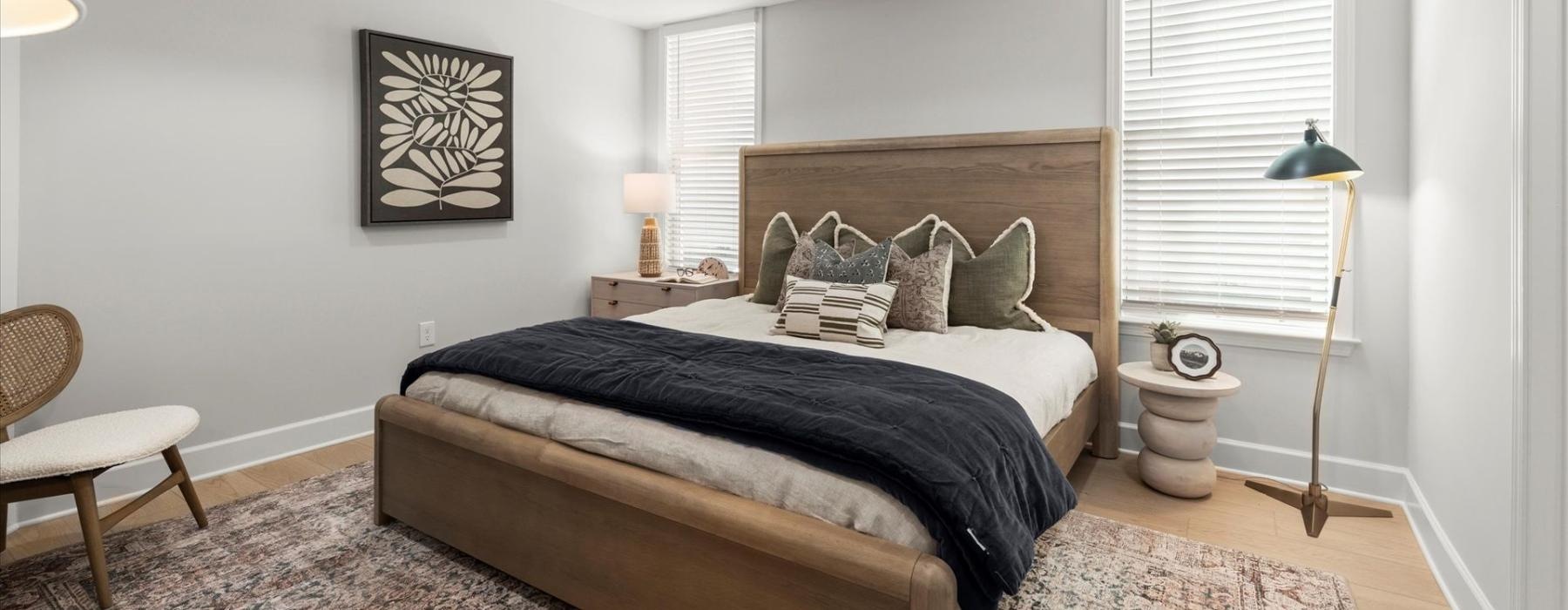 a bedroom with a bed and lamps