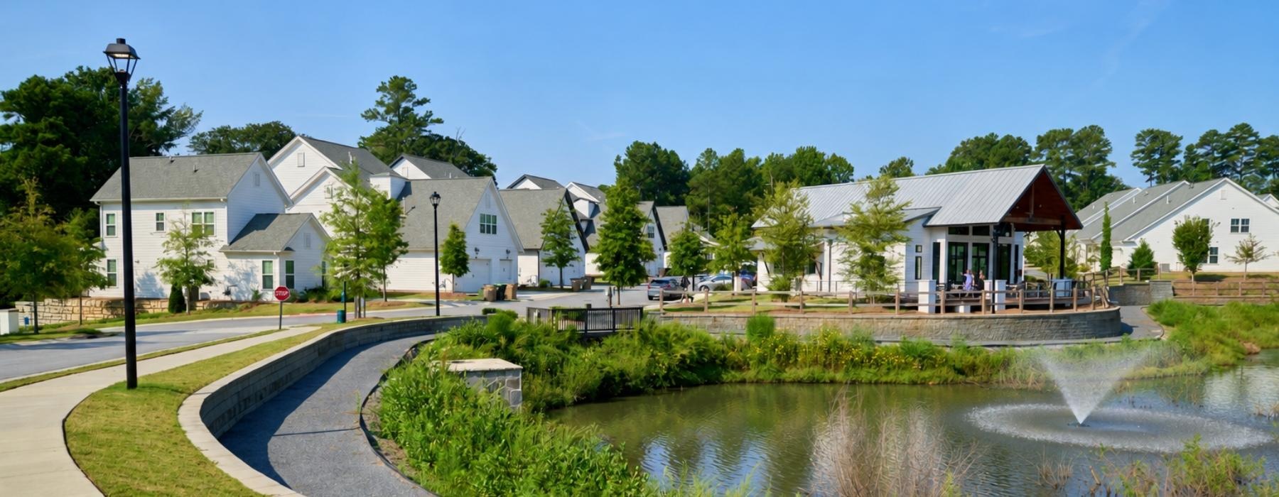 a row of houses next to a pond