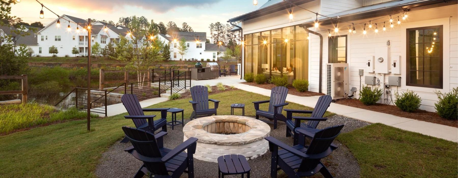 a fire pit with Adirondack chairs