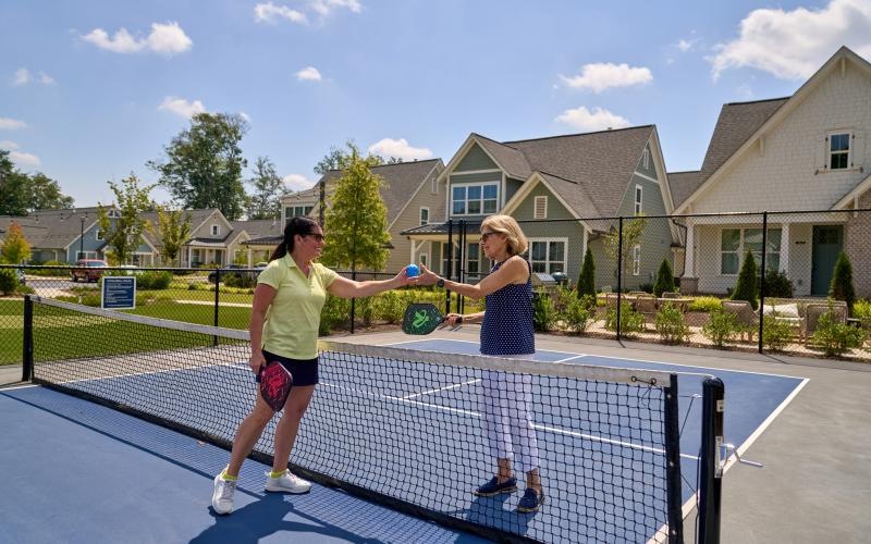 a couple of women playing pickle ball
