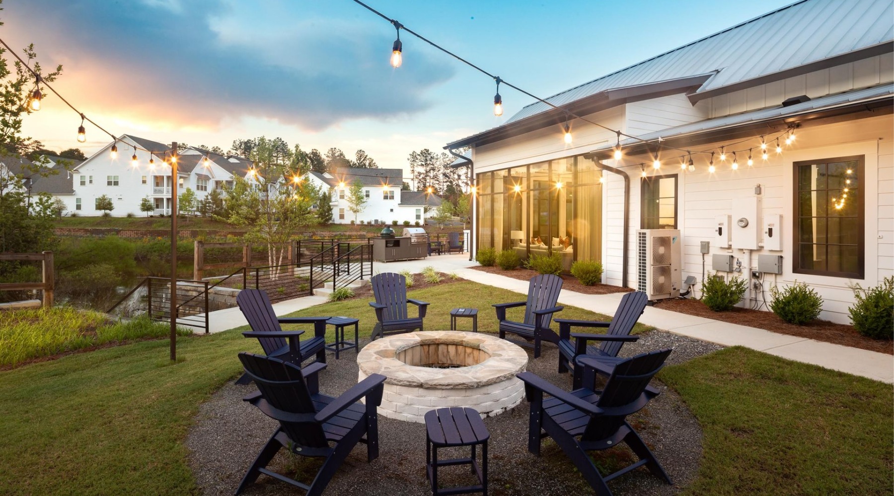 a fire pit with Adirondack chairs